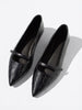 Black crocodile-embossed leather flats with pointed toe and mary-jane strap, pair shown together