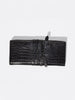 Black crocodile-embossed leather clutch with wrap-around strap detail, flat top-down product shot