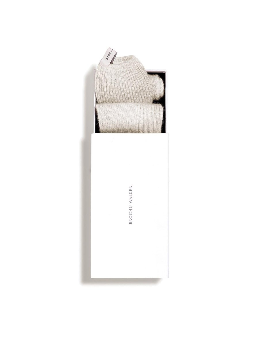 Ribbed cashmere socks in mist mélange folded inside a white Brochu Walker gift box.