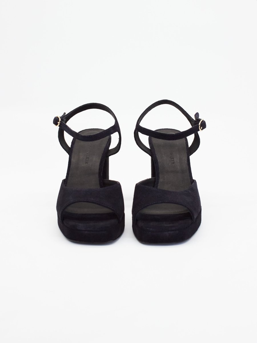 Women's black high heels with open toes, ankle straps, and chunky platform soles for added height and comfort.