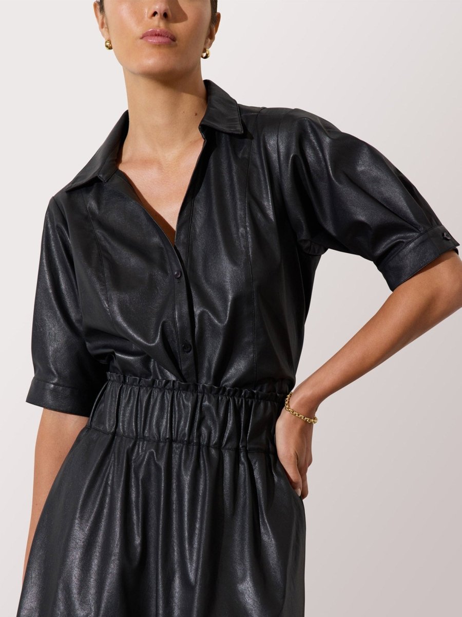 Women's leather dress in black with short sleeves, a collared neckline, and cinched elastic waist detail.