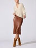Siena wrap-neck cashmere pullover in stone melange styled with a brown leather midi skirt and suede boots
