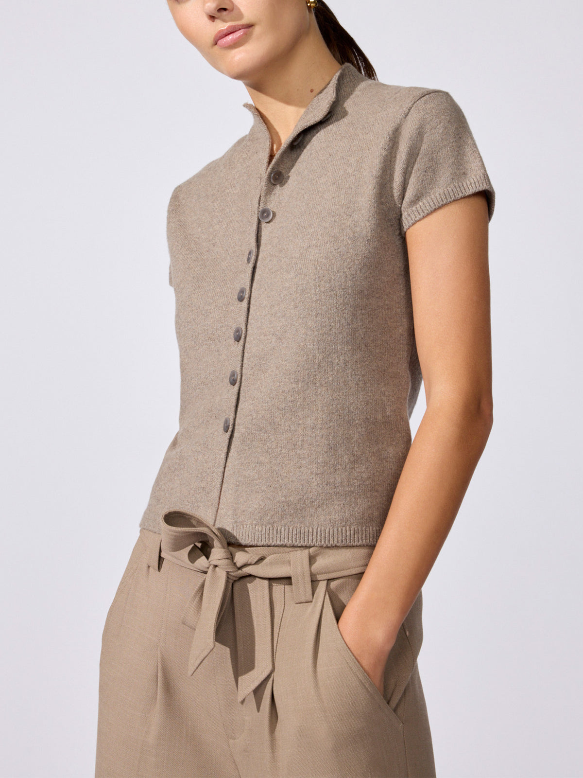 Close-up of the Emmy cardigan in otter melange, a button-front knit top styled with matching tie-waist trousers