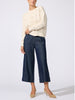 Woman wearing the Everyday multi-stitch bright crew sweater in oatmeal melange with dark blue wide-leg denim pants and beige heels