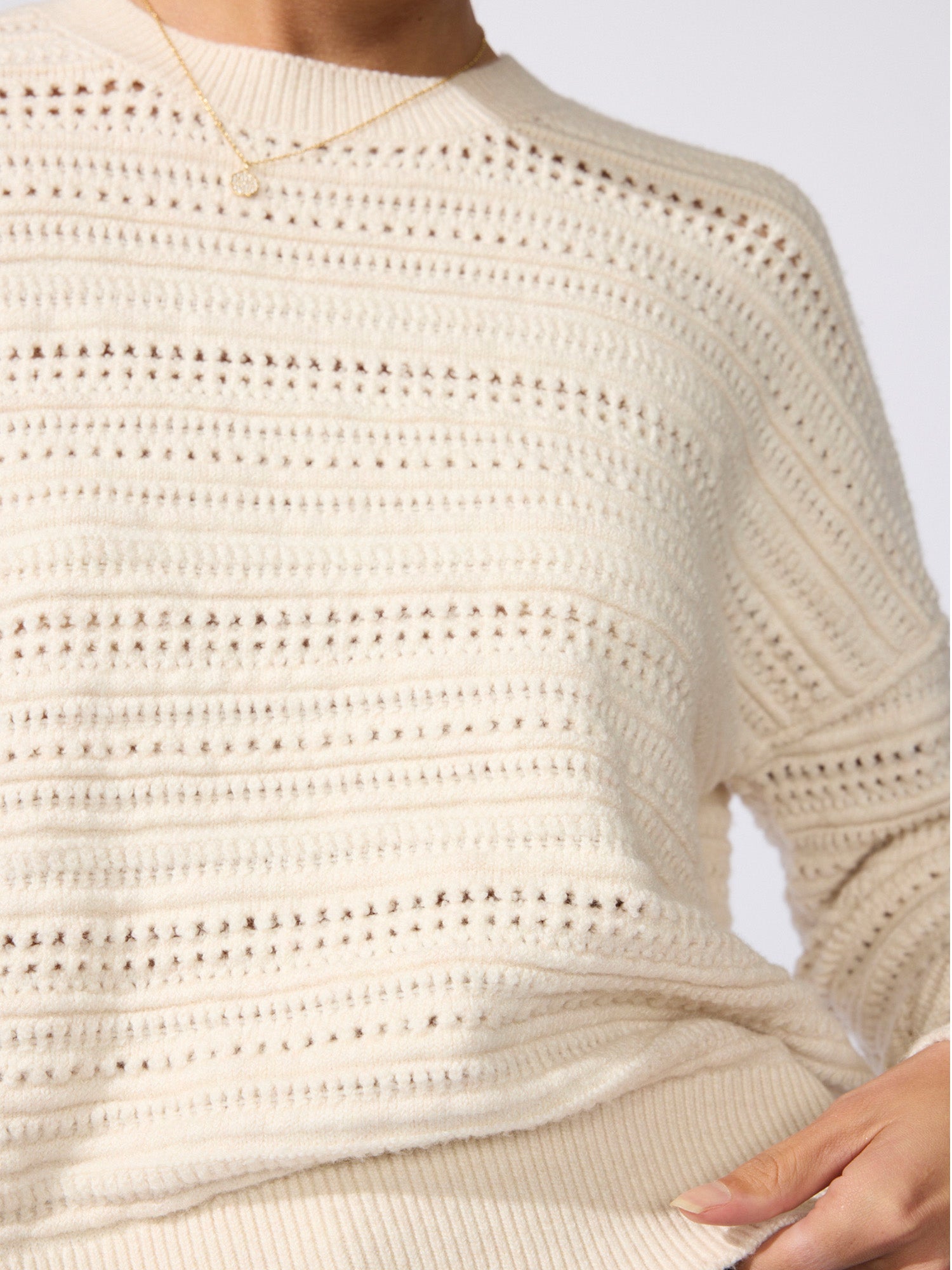 Close-up of the Everyday multi-stitch bright crew sweater in oatmeal melange, showing its open-knit texture
