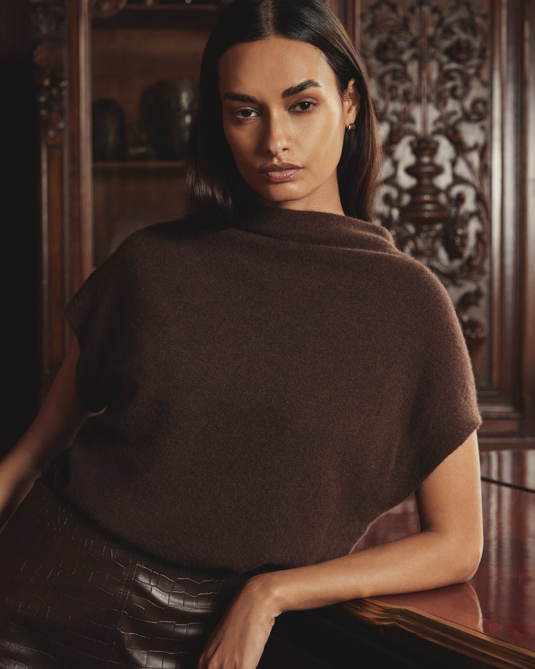 Woman wearing a brown draped funnel-neck cashmere sweater