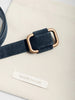 Classy belt in dark navy suede with a brushed gold rectangular buckle displayed on a cream Brochu Walker dust bag.