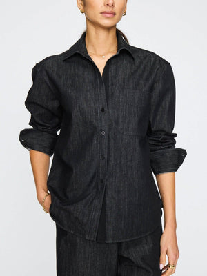Women's denim button down shirt in dark indigo with a relaxed fit, front pocket, and rolled-up sleeves.
