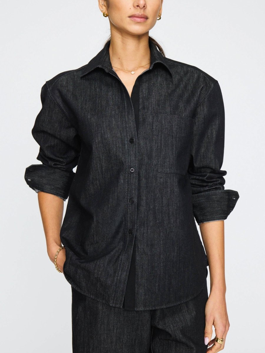 Women's denim button down shirt in dark indigo with a relaxed fit, front pocket, and rolled-up sleeves.