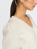 Deep V-neck women's sweater in ivory with soft puff sleeves and subtle ribbing at the cuffs.