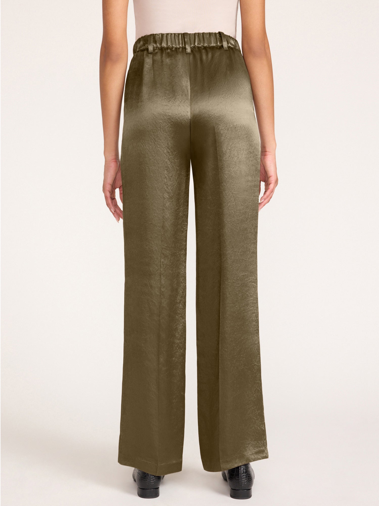 Back view of olive green satin pants showing the elastic waistband detail