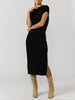 Women's black midi dress with short cap sleeves and a side slit, styled with tan suede boots