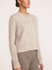 Woman wearing the Brochu Walker Archie Layered Cardigan in Gravel Stone Melange, a cropped knit cardigan with raw frayed edges, paired with taupe trousers.
