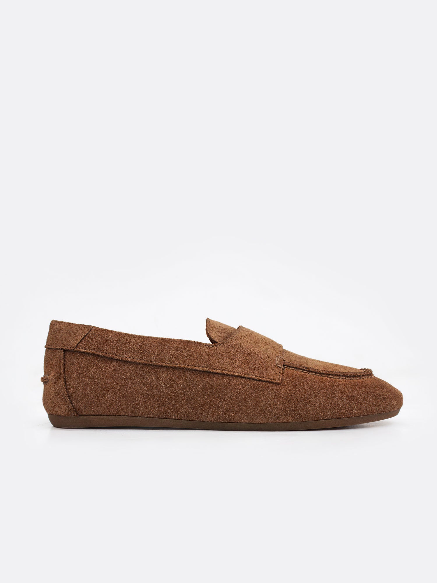 Profile side view of a tan suede loafer showing the low, rounded silhouette on a white background.