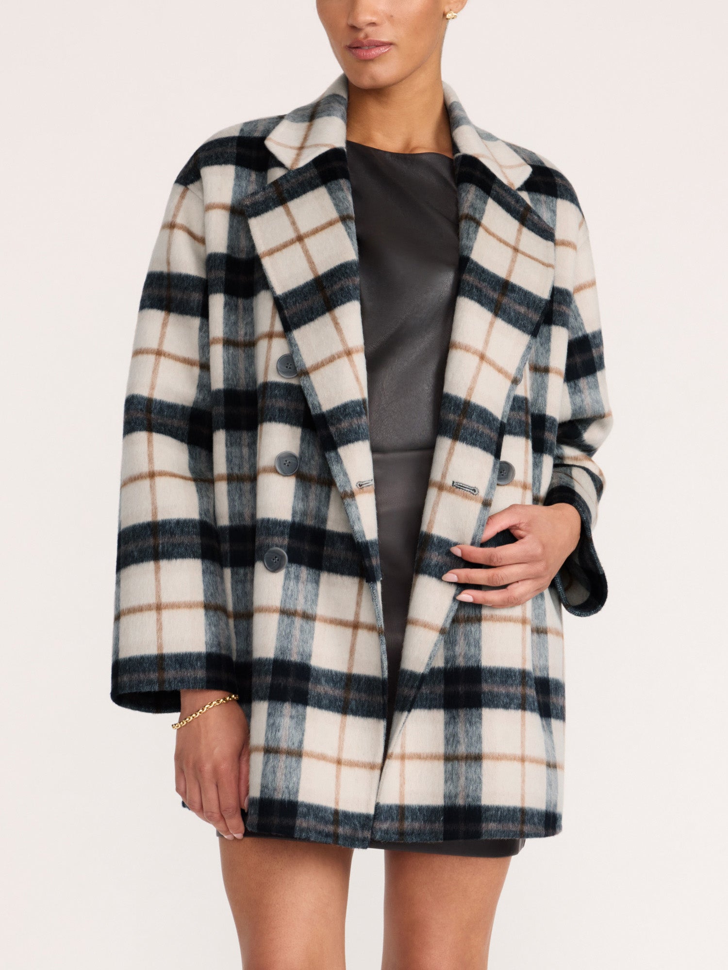 Woman wearing the Brochu Walker Bodhi Double Breasted Plaid Coat in Montclair Plaid, a wool plaid coat worn open over a gray dress.