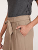 Close-up of the Brochu Walker Duke Suit Pant in Tawny, high-waisted wide-leg trousers with a fabric tie belt and side pocket.