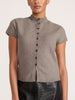 Front view of a woman wearing the Emmy cotton-wool cardigan in otter melange, showing the button-front detail, paired with black croc-embossed bottoms.