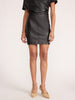 Front waist-down view of the Brochu Walker Esme Miniskirt in Black Onyx, a faux-leather mini skirt paired with a leather top and beige heels.