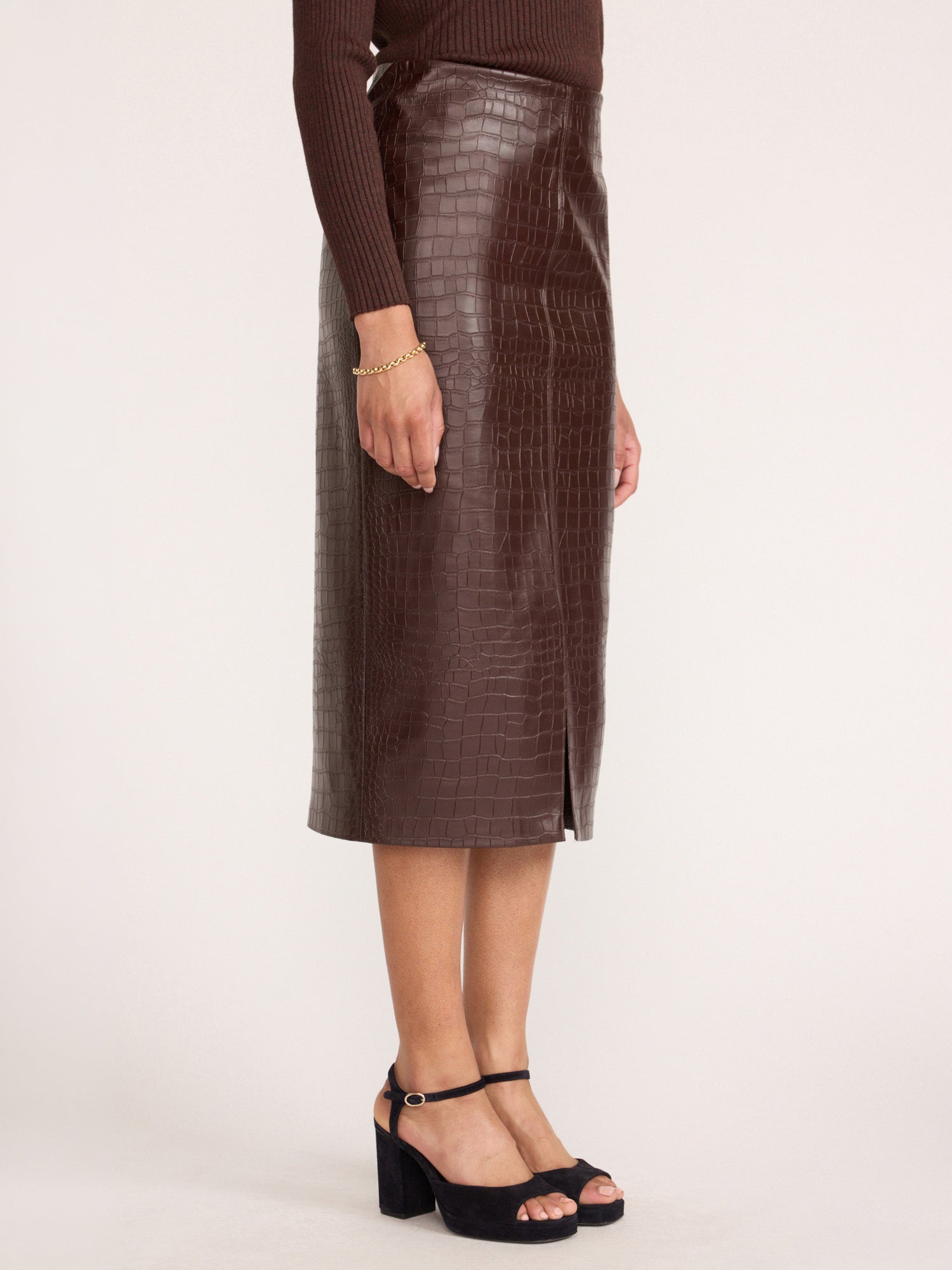 Vegan croco-embossed midi skirt in carob with front slit, side view with platform sandals