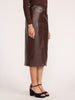 Vegan croco-embossed midi skirt in carob with front slit, side view with platform sandals