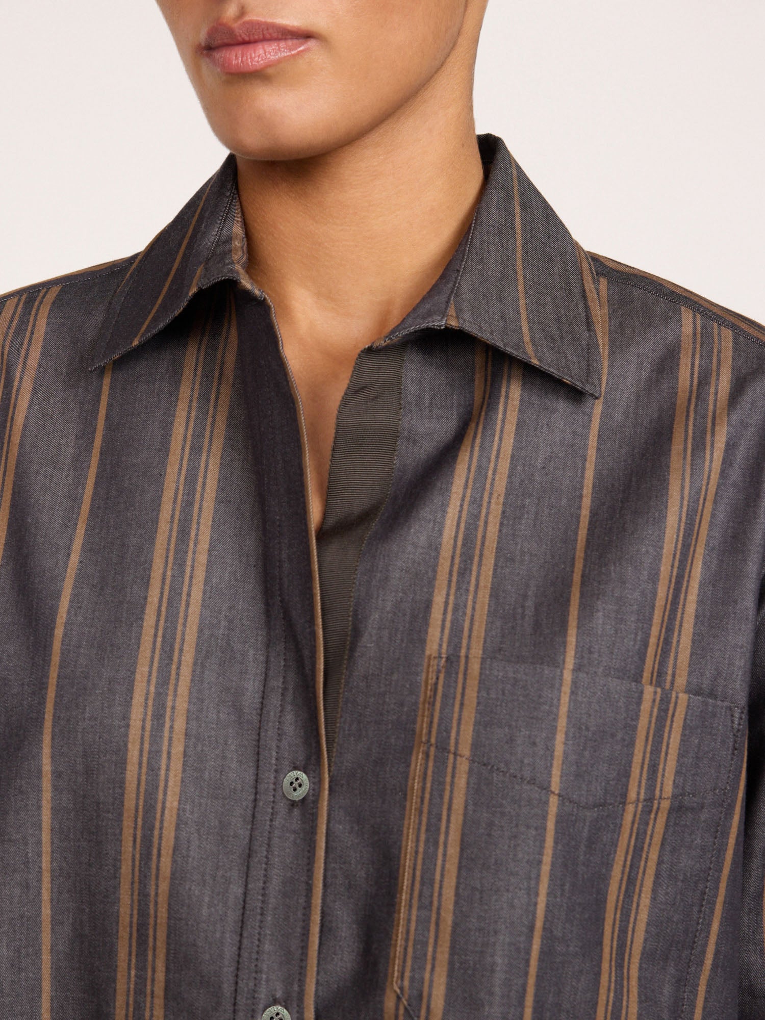 Close-up of the collar and button placket on the Brochu Walker Everyday Shirt in Sedona Stripe, a charcoal cotton shirt with tan vertical stripes.