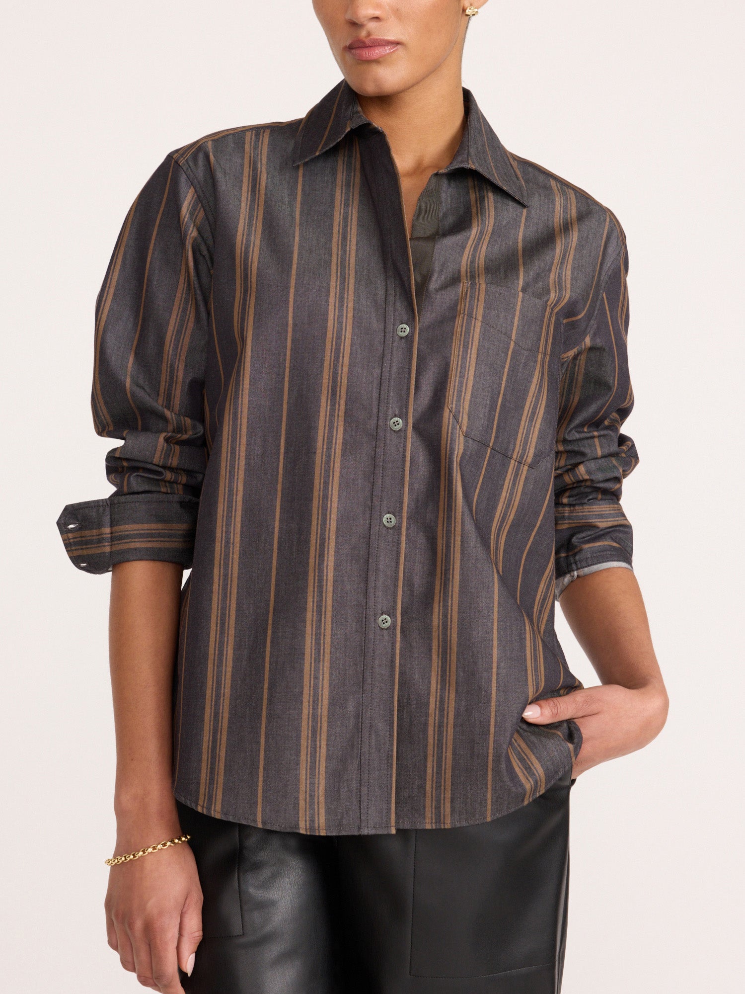 Woman wearing the Brochu Walker Everyday Shirt in Sedona Stripe, a striped cotton button-down shirt paired with black leather pants.