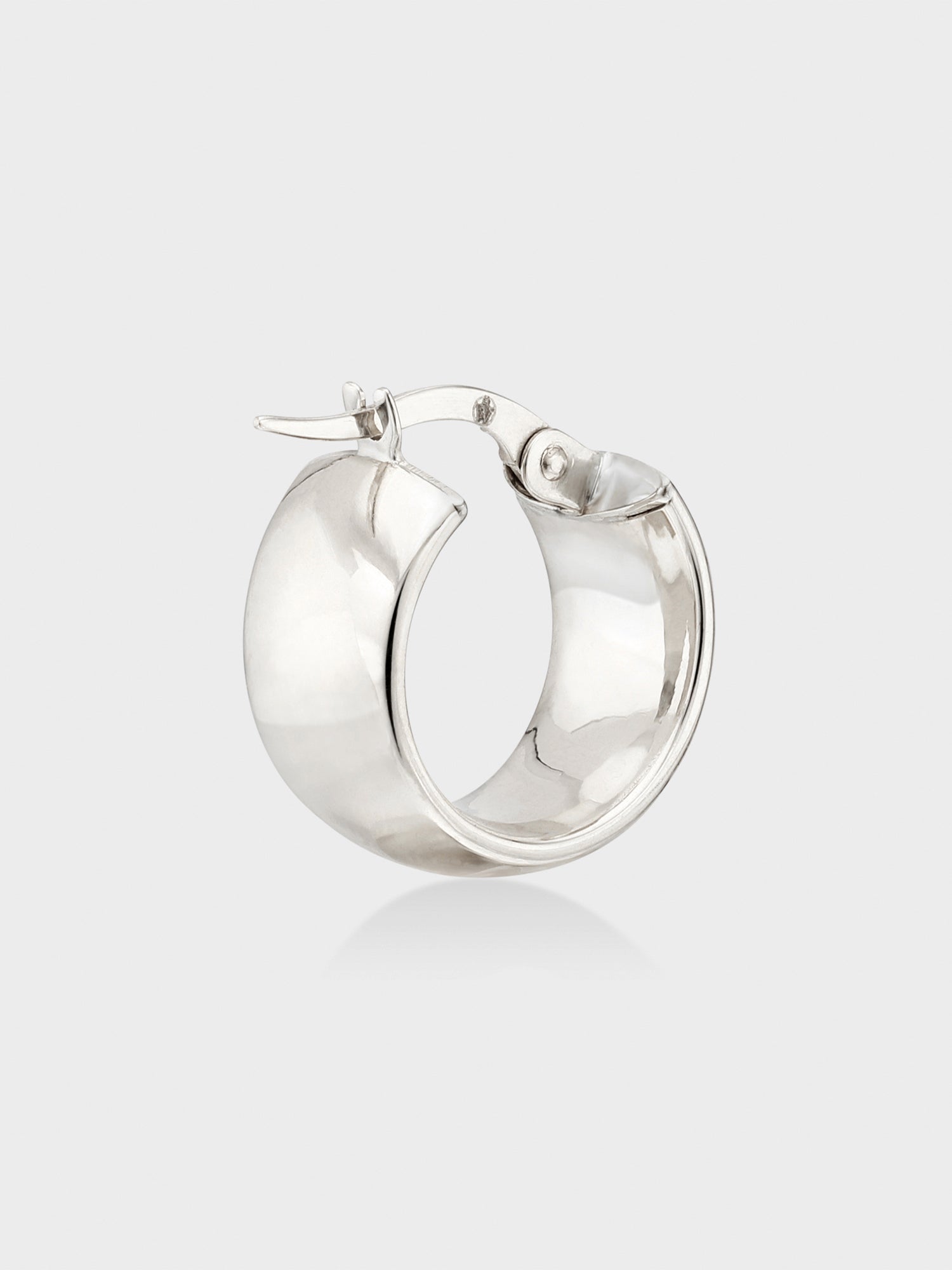 Single white gold mini hoop earring with a wide domed band and hinged clasp