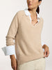 Model wearing the Ella layered pullover in camel over a white collared shirt with cream trousers