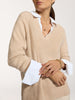 Close-up of the Ella layered pullover in camel, showing the V-neck and white shirt cuffs