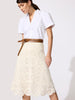 Classy white top with short sleeves and a V-neckline tucked into a cream crochet midi skirt with a tan leather wrap belt.