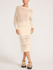 Full-length view of the ecru pointelle crewneck sweater styled with a matching open-knit midi skirt and tan platform sandals.
