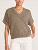 Model in the bronze metallic V-neck Gaia Tee styled with tailored ivory pants.