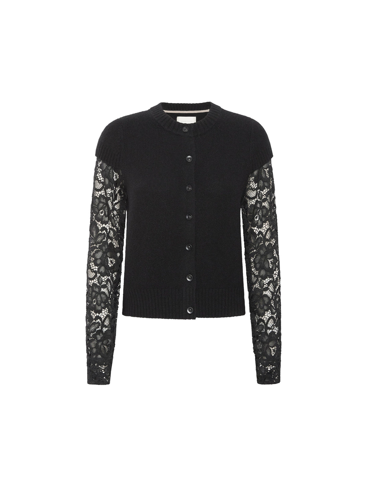 Seated woman wearing a black button front cardigan with floral lace sleeves and a black lace trim skirt