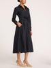 Women's black midi shirt dress with a tie waist and side pockets, styled with beige heels
