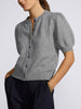 Havana short-sleeve knit cardigan in grey with puff sleeves, worn with navy pinstripe trousers