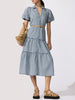 Classy denim dress with puff sleeves, tiered skirt, and tan belt styled with suede sandals and a tan bag.