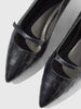 Close-up of black croc-embossed Mary Jane flats, showing the pointed toe and instep strap