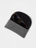 Gold-frame aviator sunglasses tucked inside a soft gray foldover case