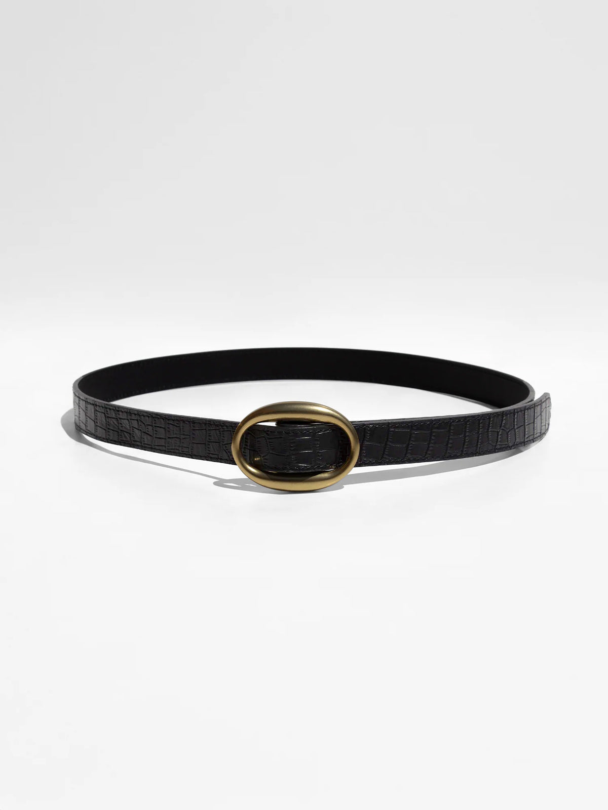 Black woven leather belt with a polished gold oval buckle, shown on a white studio background