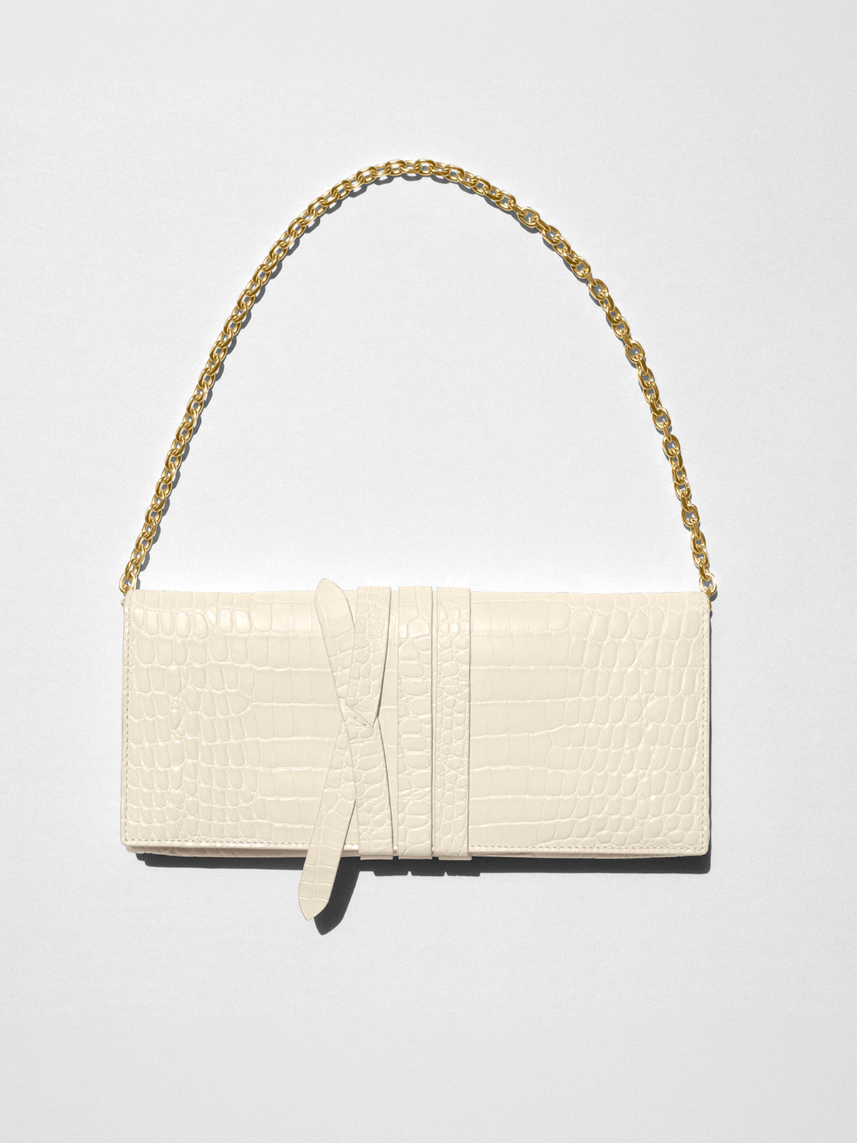 Ivory croc-embossed leather clutch bag with a gold chain shoulder strap and buckle detail