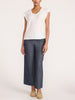 Full-length view of the white Koda short sleeve tee styled with wide-leg chambray pants and tan suede loafers.