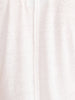 Close-up fabric detail of the white Koda tee showing its lightweight slub-knit texture and center seam.