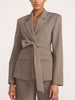 Belted blazer and trouser suit in gravel melange gray, close-up front view with tie-waist and flap pockets
