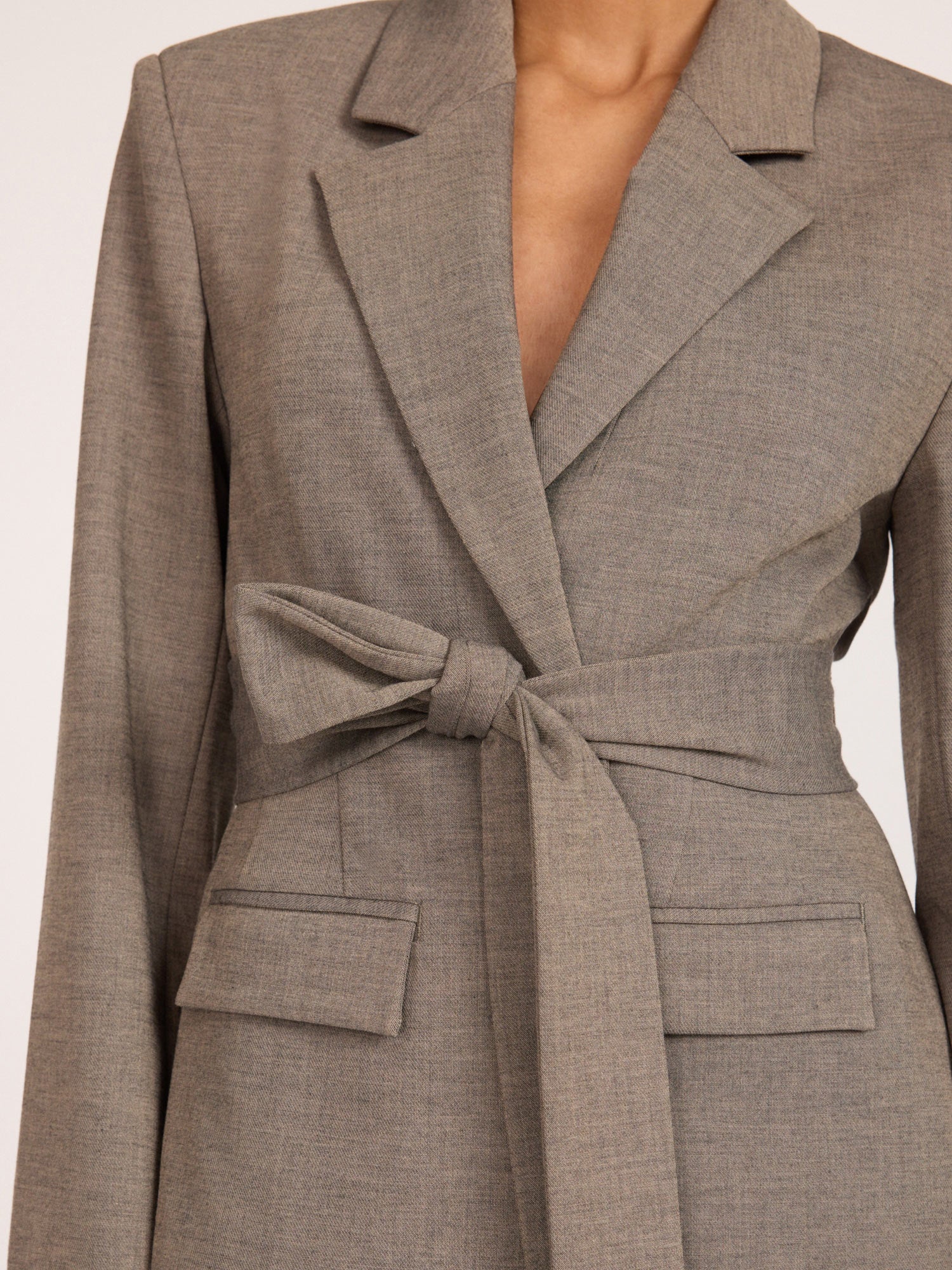 Belted blazer in gravel melange gray, close-up of tie-waist and flap pocket detail