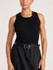 Front view of the black Leo Tank tucked into a black skirt finished with a black leather belt.