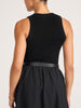 Back view of the black Leo Tank tucked into a black skirt with a black leather wrap belt.