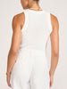 Back view of the white Leo Tank tucked into ivory women's pants, finished with pearl jewelry.