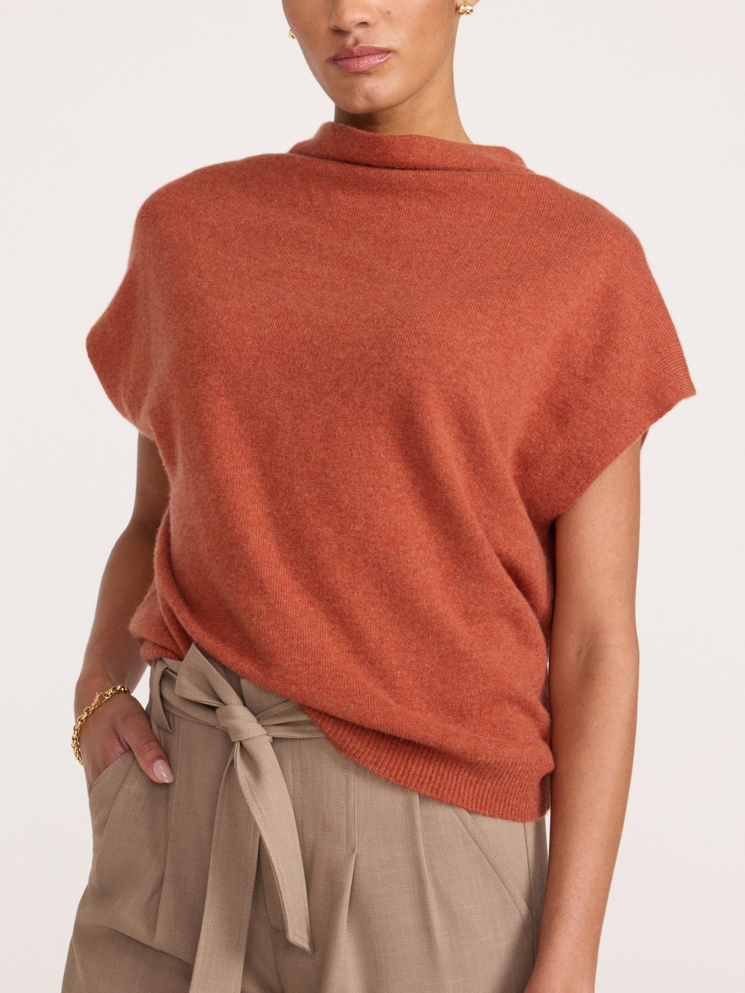 Morten funnel-neck cashmere top in canyon orange melange, close-up with beige tie-waist trousers