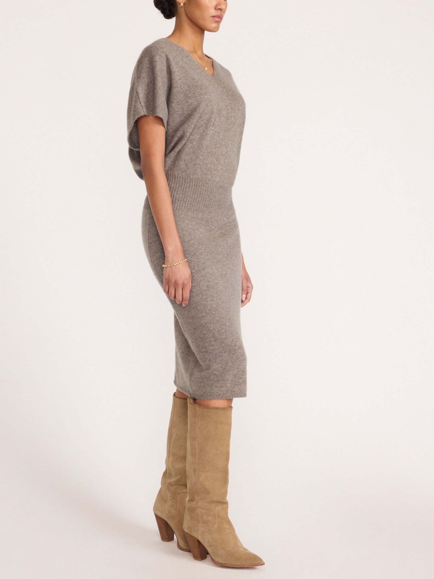 Ophi V-neck cashmere sweater dress in otter melange, side profile with suede knee-high boots