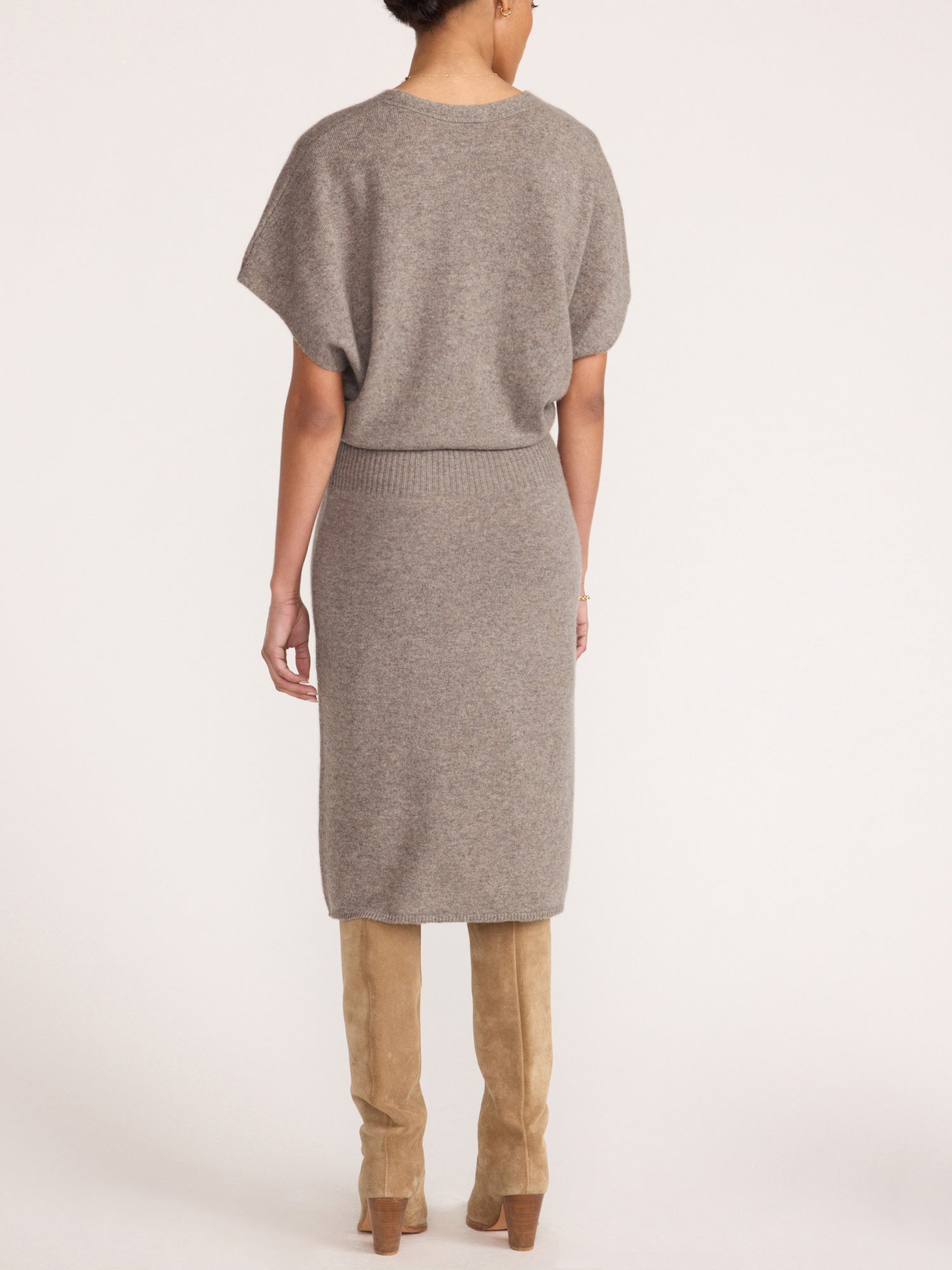 Ophi V-neck cashmere sweater dress in otter melange, back view with suede boots